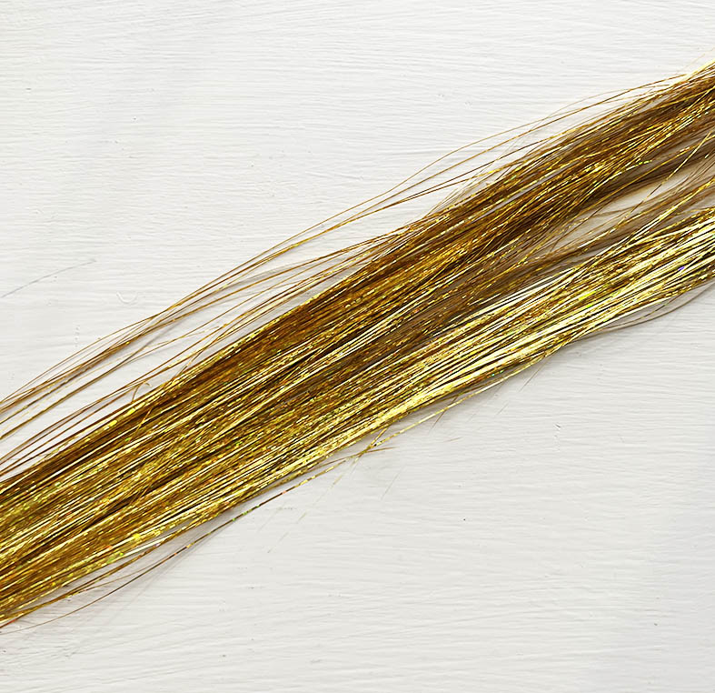 Hair tinsel in gold.